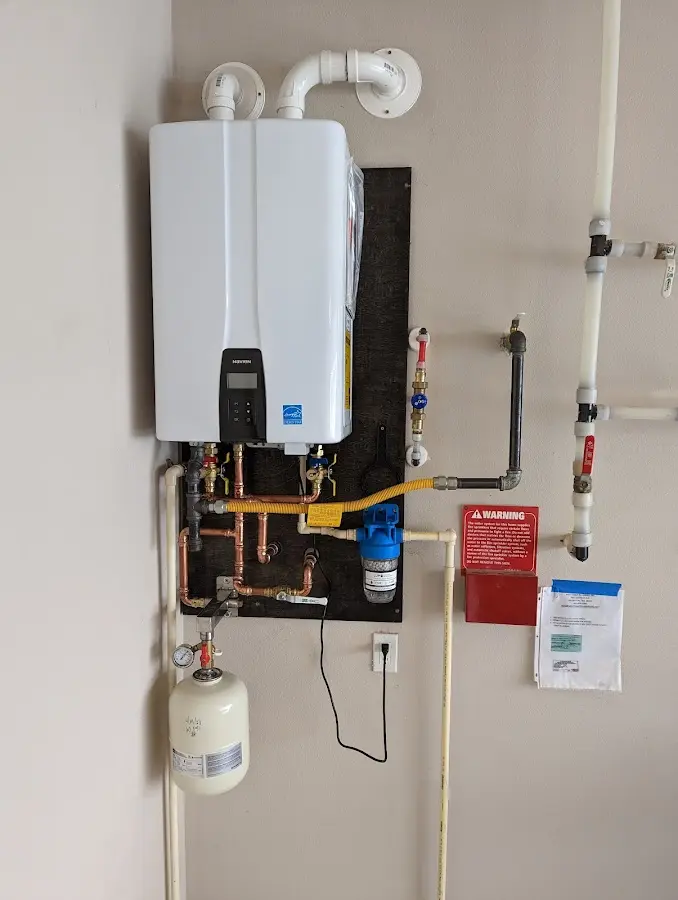 Professional plumber installing copper piping in a Lake Arbor home